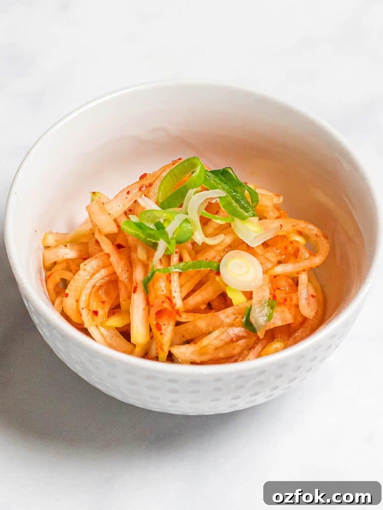 Spicy Korean Radish Salad (Musaengchae) — Authentic Recipe 4 spicy Korean daikon radish salad in a small white bowl