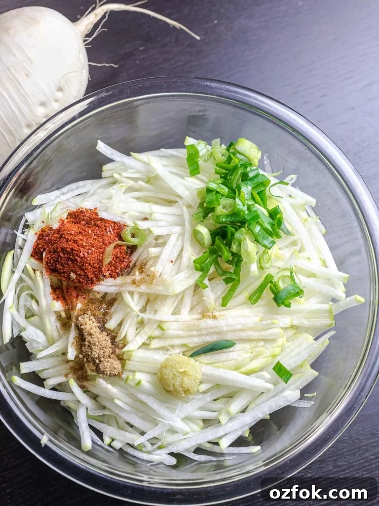 Spicy Korean Radish Salad (Musaengchae) — Authentic Recipe 7 ingredients for daikon radish salad in a glass bowl