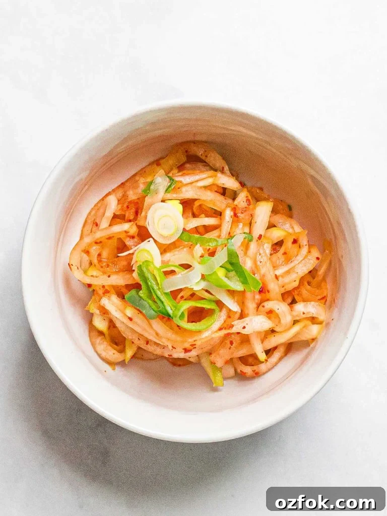 Spicy Korean Radish Salad (Musaengchae) — Authentic Recipe 8 daikon radish salad in a small white bowl, musaengchae