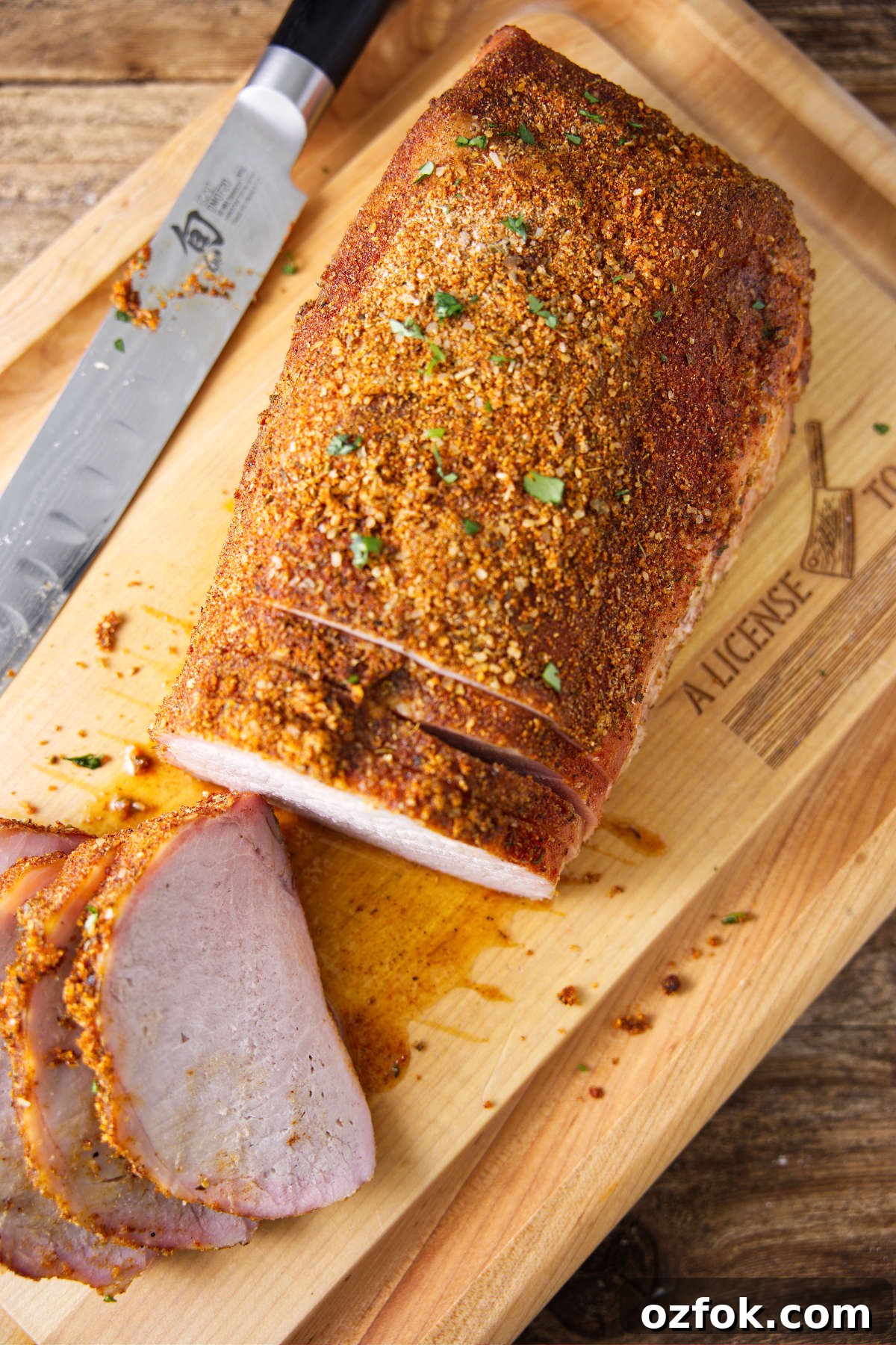 Sliced smoked pork loin on cutting board.