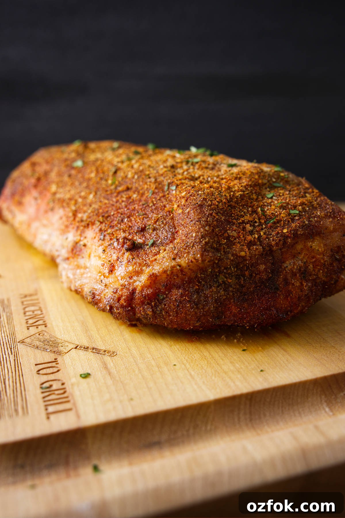 Entire smoked pork loin on a cutting board.