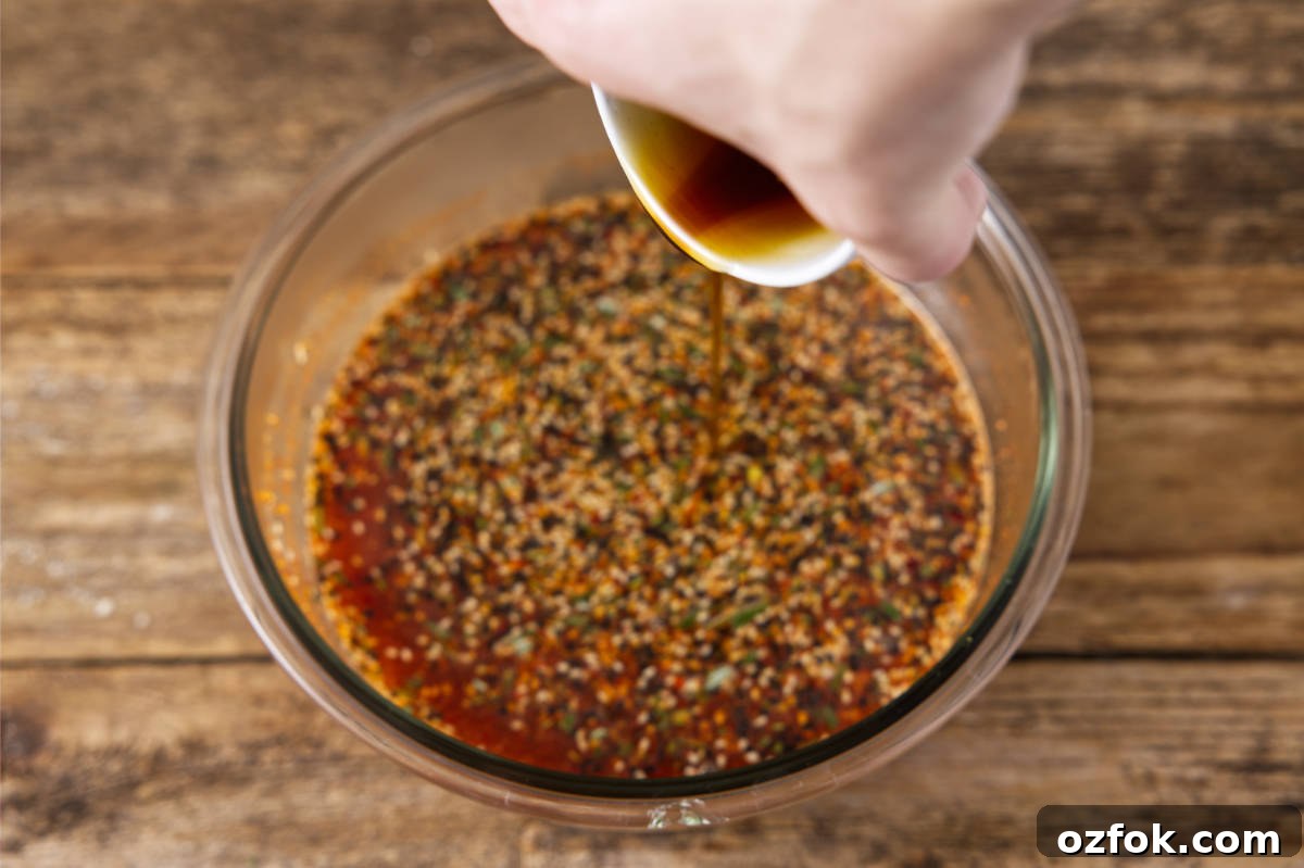 Pouring maple syrup into bowl with brine ingredients.