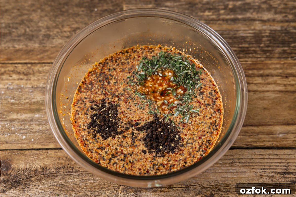 Combining aromatics to pork brine in a glass mixing bowl.