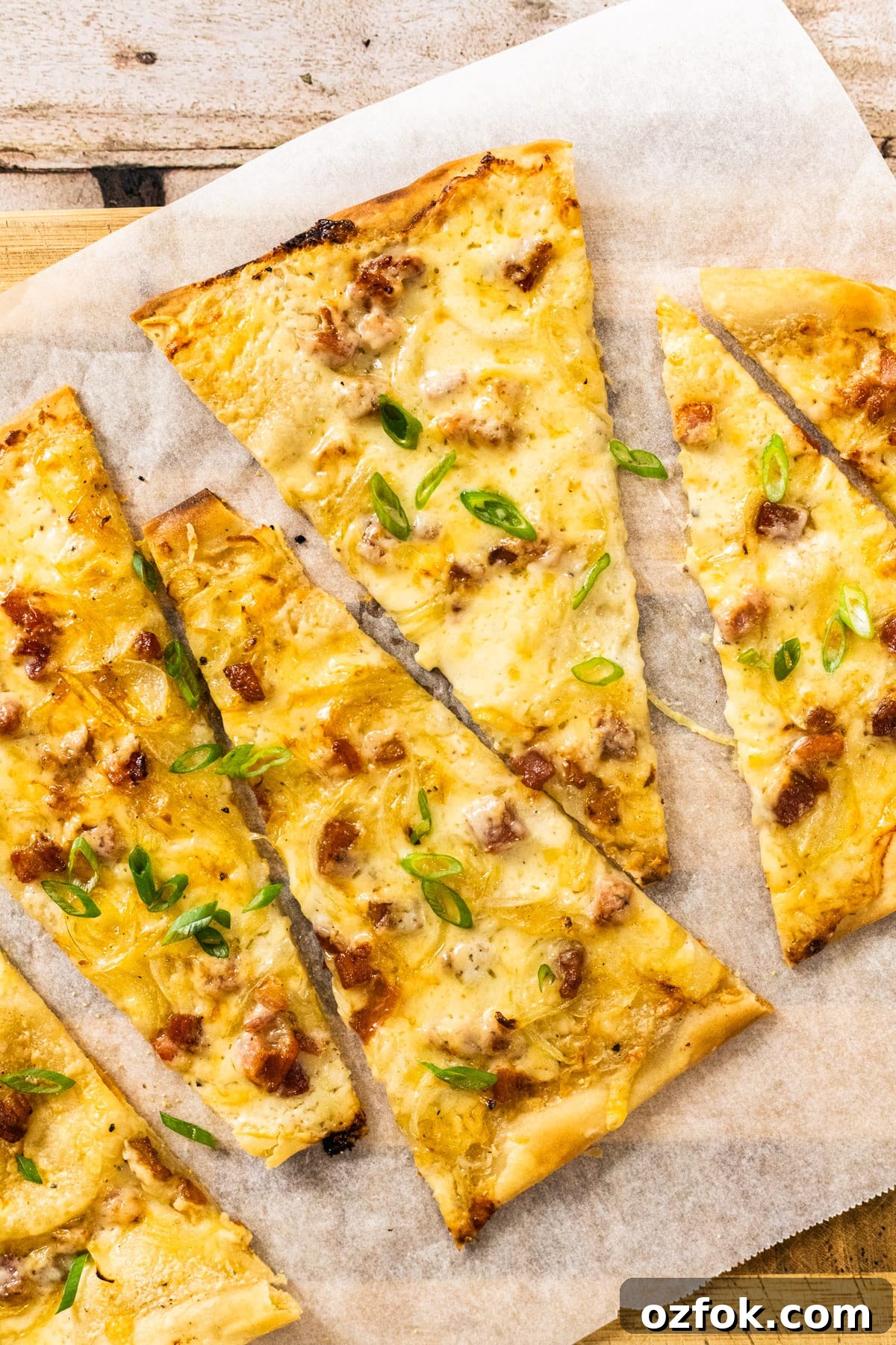 Flammkuchen: Authentic German Tarte Flambée Recipe and Tips 2 A top down view of a sliced German pizza.
