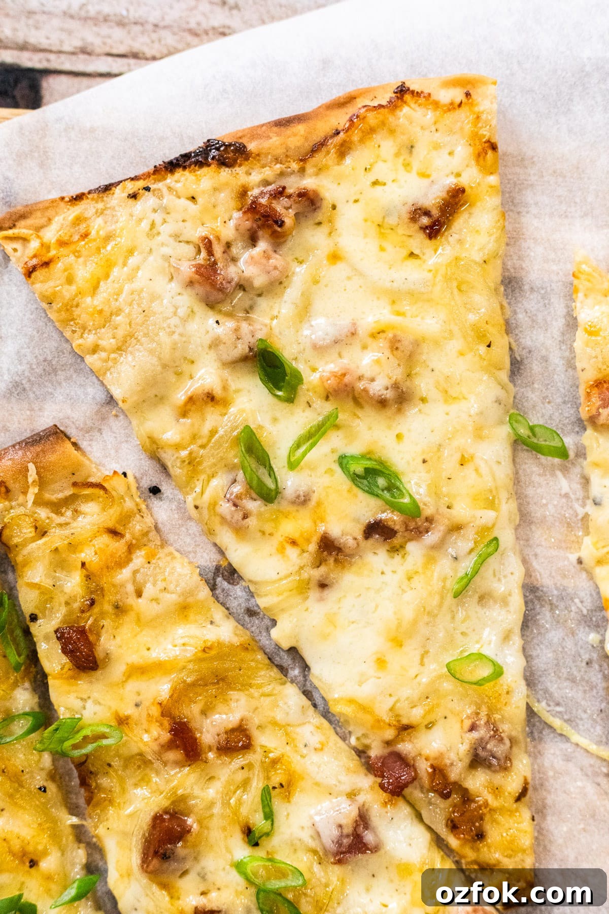 Flammkuchen: Authentic German Tarte Flambée Recipe and Tips 5 A close up view of a slice of German pizza.