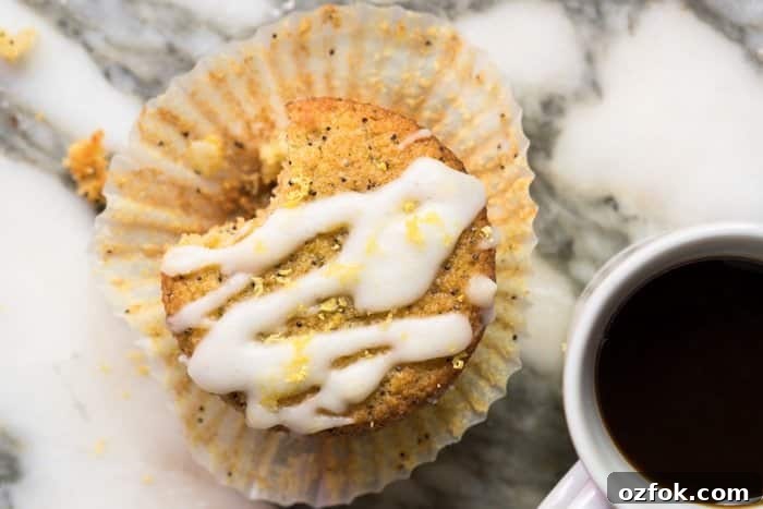 A keto lemon poppy seed muffin with a mug of coffee