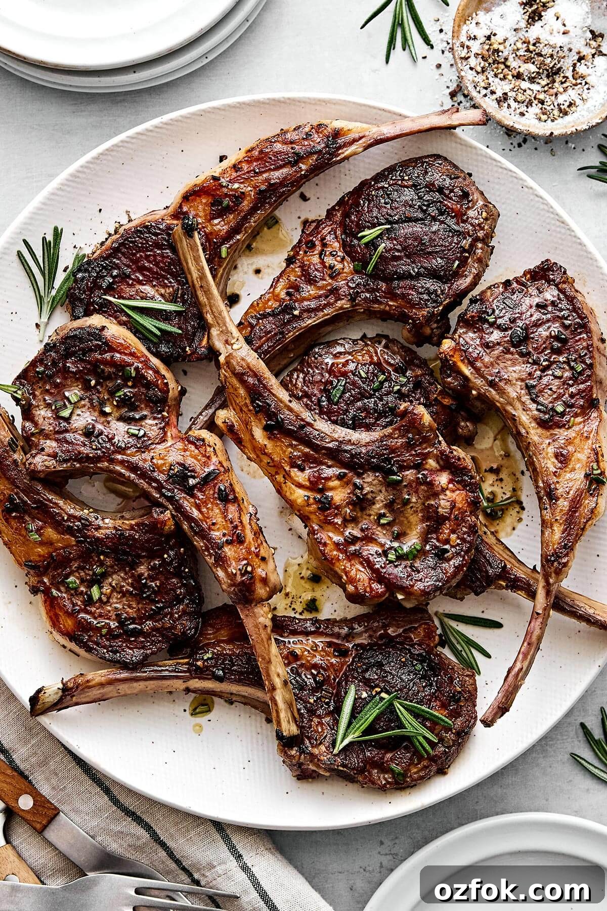 A plate of rosemary grilled lamb chops for holiday dinners like Easter or summer cookouts.