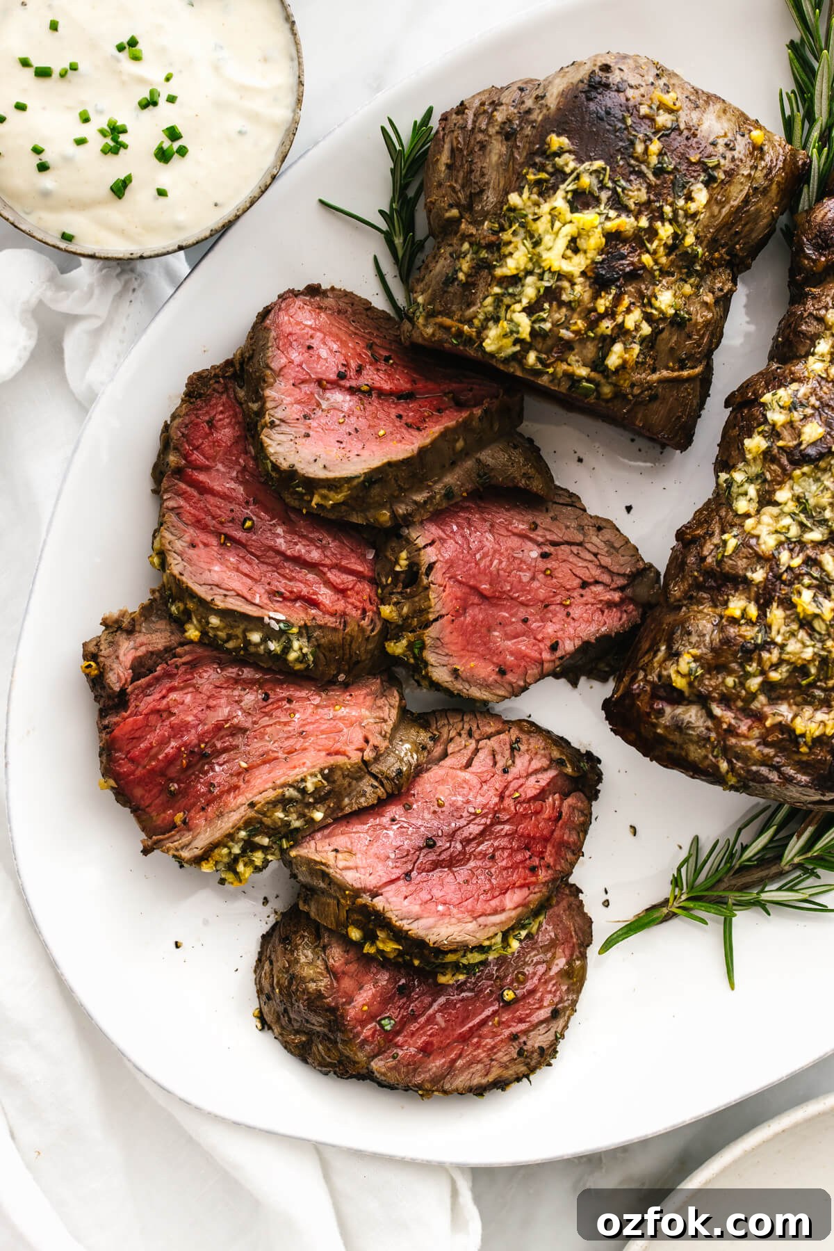 Slices of beef tenderloin on a plate.
