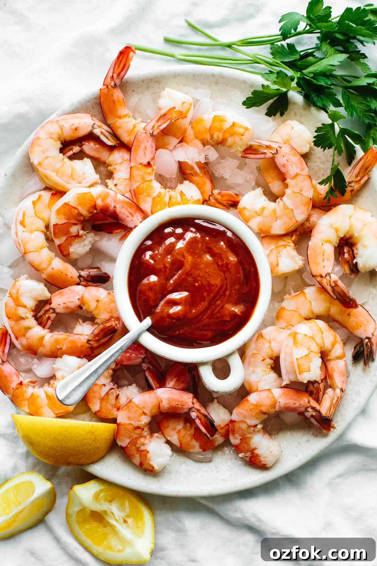 Shrimp cocktail on a platter with sauce.