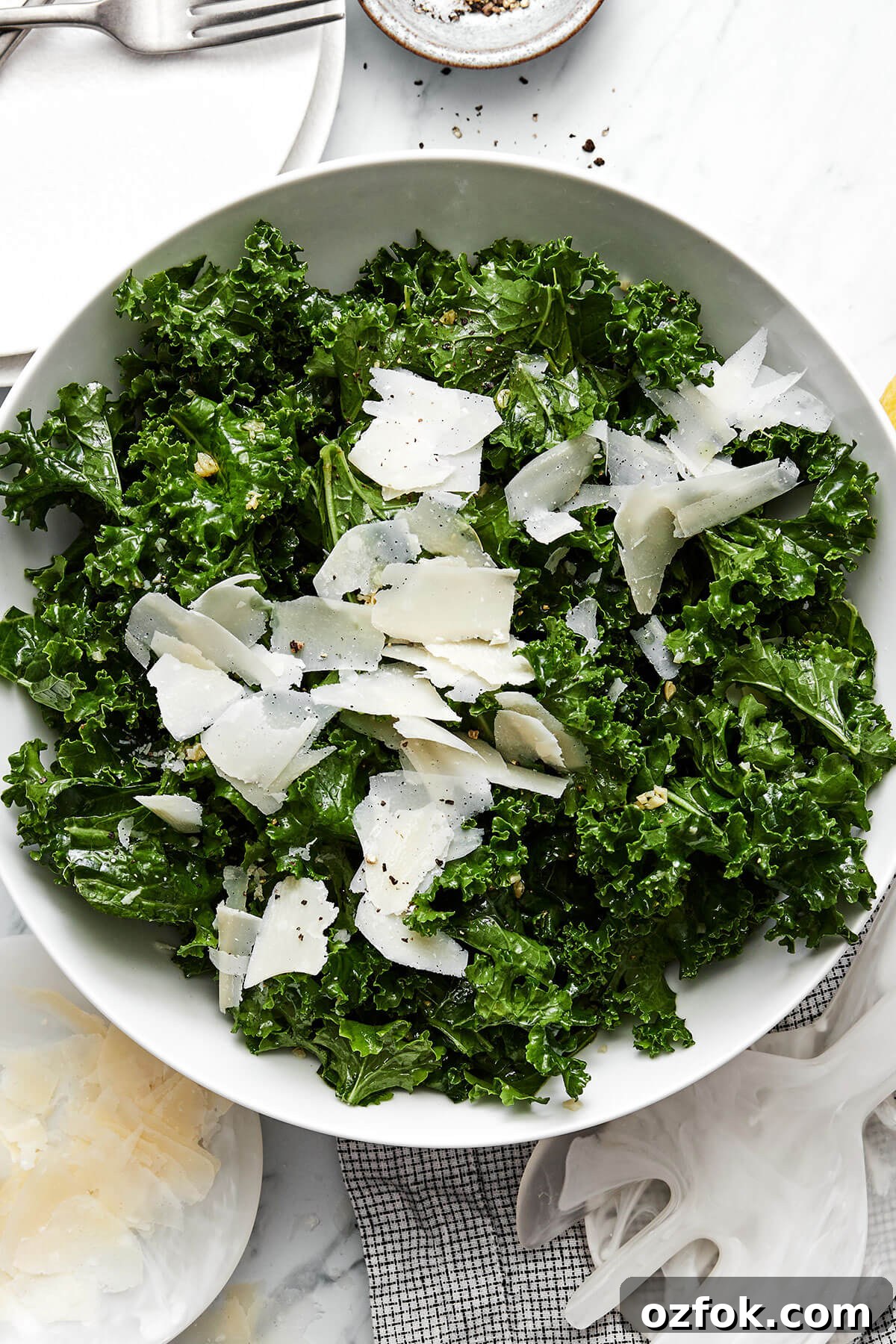 A bowl of kale salad with parmesan.