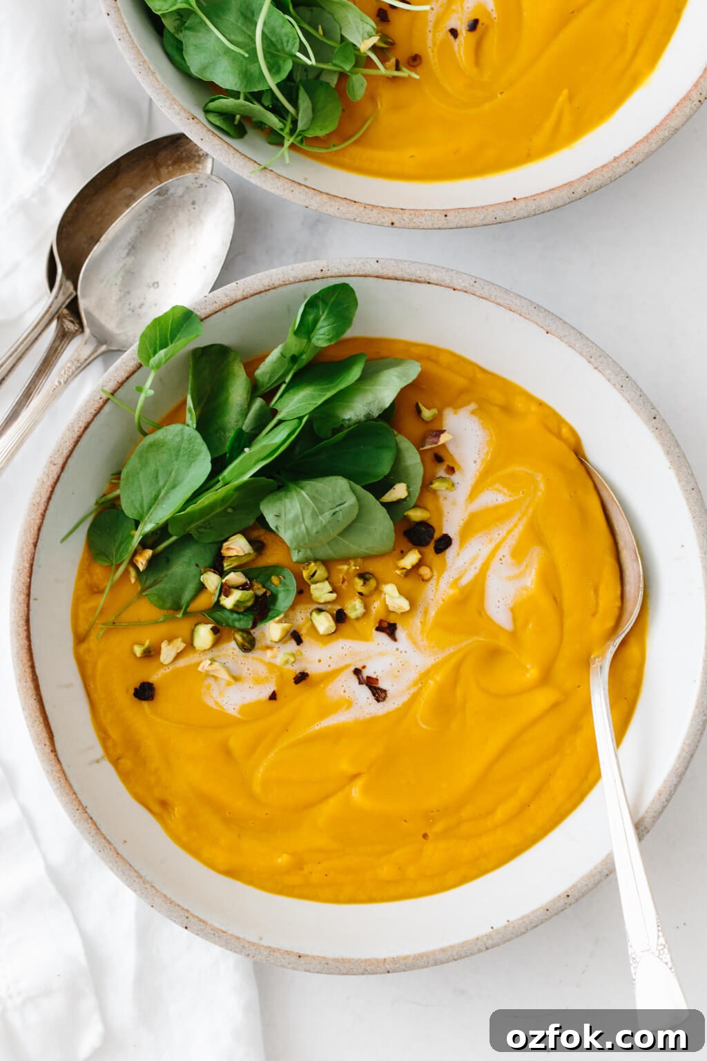 Sweet potato soup topped with watercress and coconut cream.