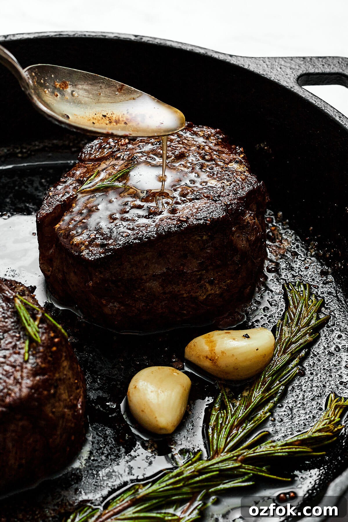 Spooning butter sauce over filet mignon