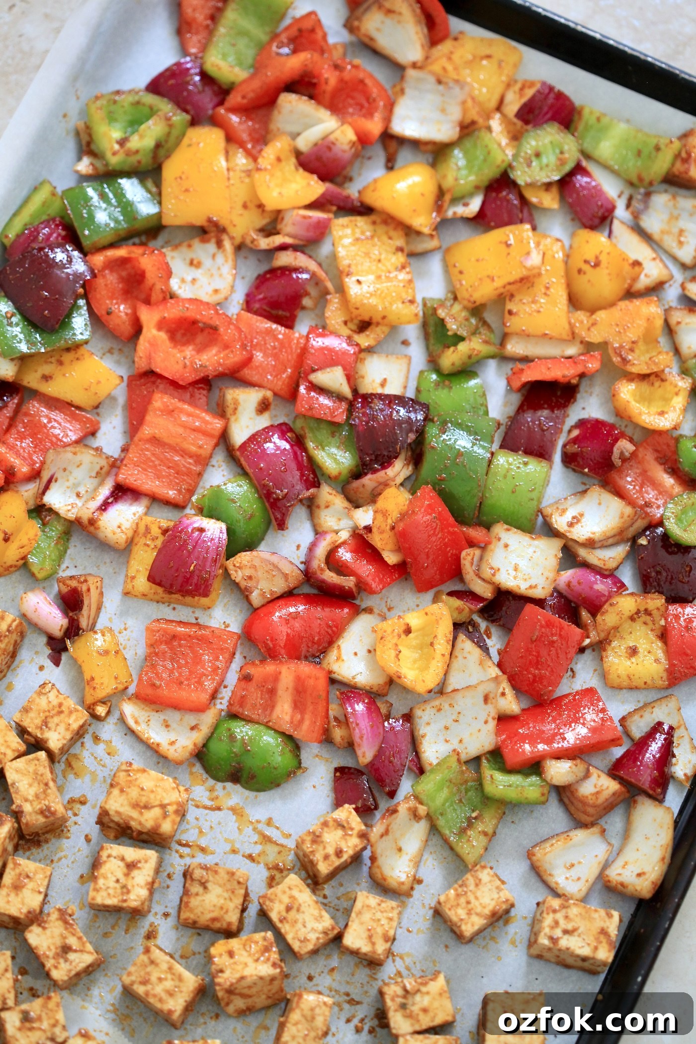 Flavor-Packed Baked Tofu Fajitas with Roasted Veggies 5 uncooked veggies and tofu on sheet pan.