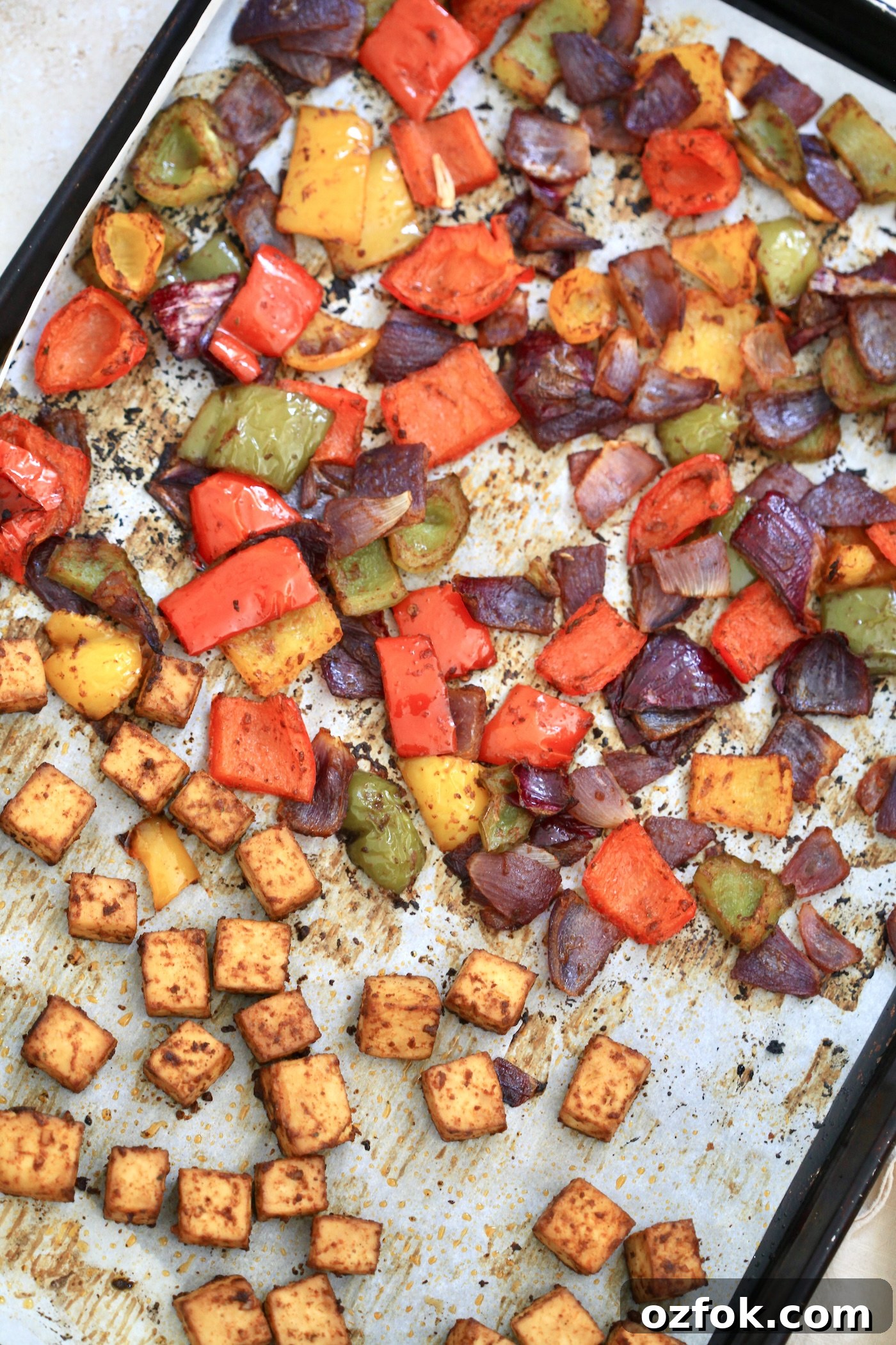 Flavor-Packed Baked Tofu Fajitas with Roasted Veggies 6 cooked veggies and tofu on pan.
