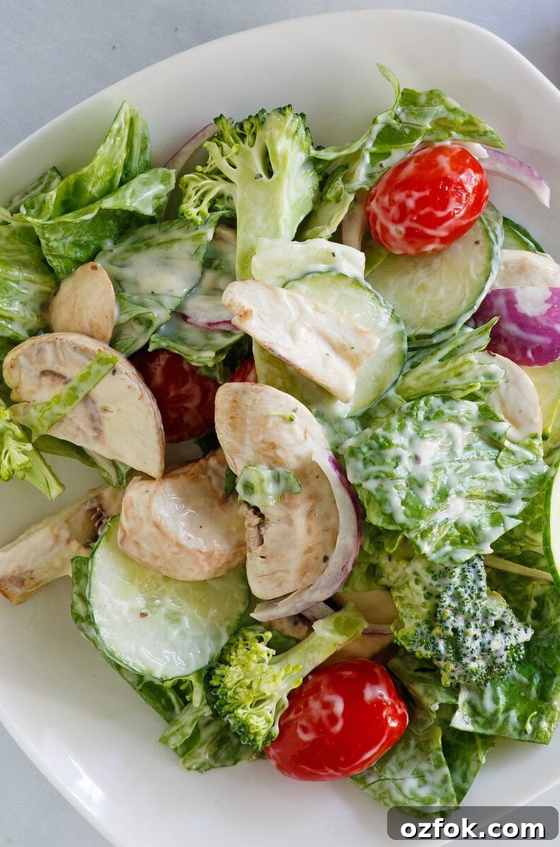 Romaine and Broccoli Salad in a white bowl