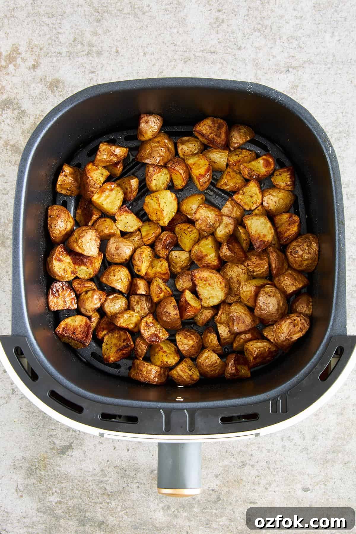 Crispy Air Fryer Greek-Style Lemon Potatoes 5 Cooked Greek potatoes in an air fryer basket.