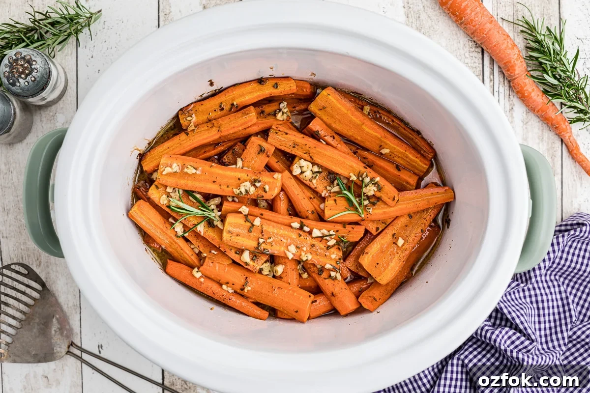 overhead shot of honey garlic carrots with rosemary on top.