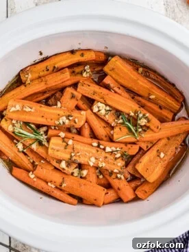 overhead shot of honey garlic carrots with rosemary on top.