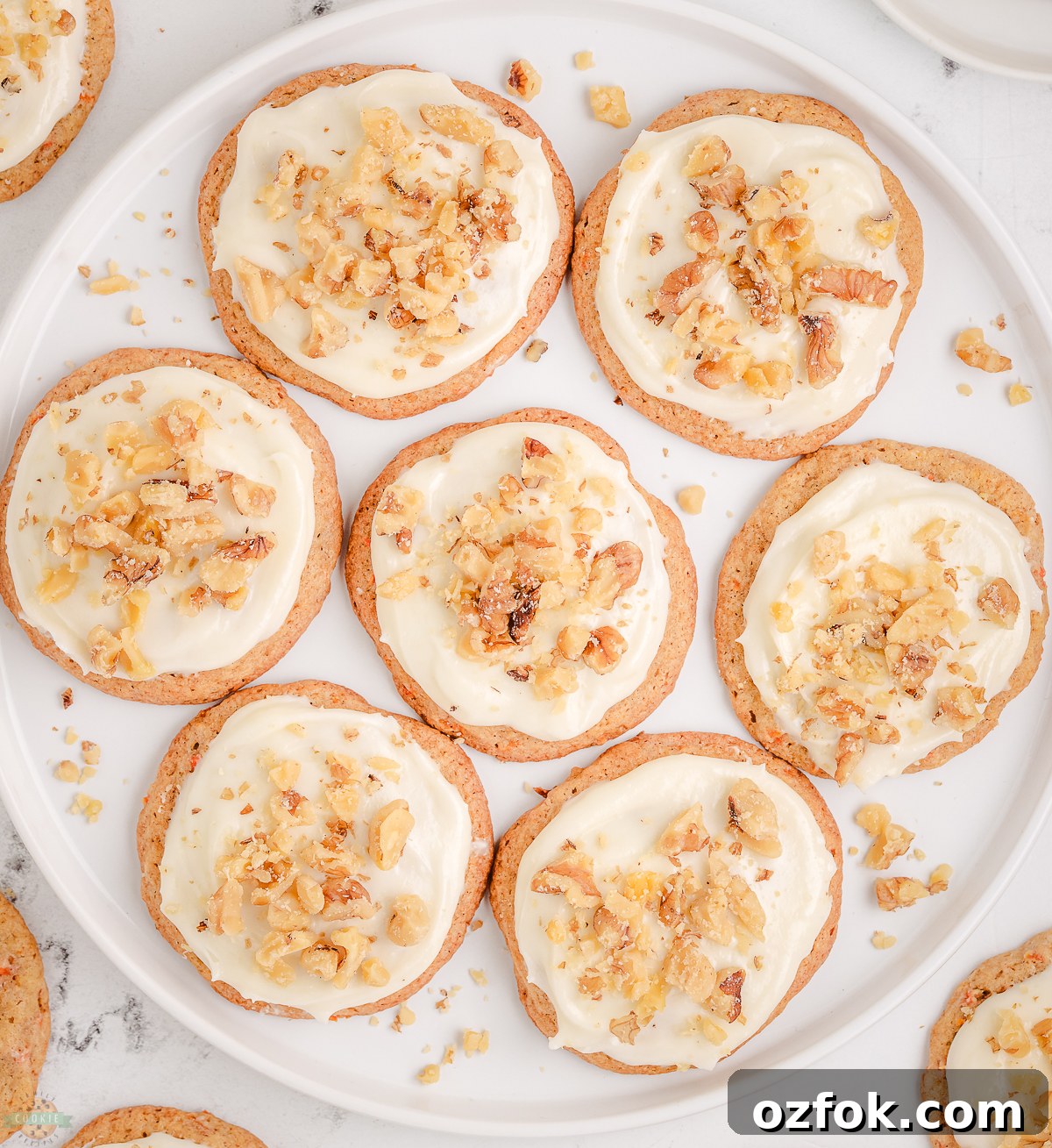 Soft Carrot Cake Cookies with Cream Cheese Frosting 4 plate of Carrot Cake Cookies topped with cream cheese frosting and walnuts