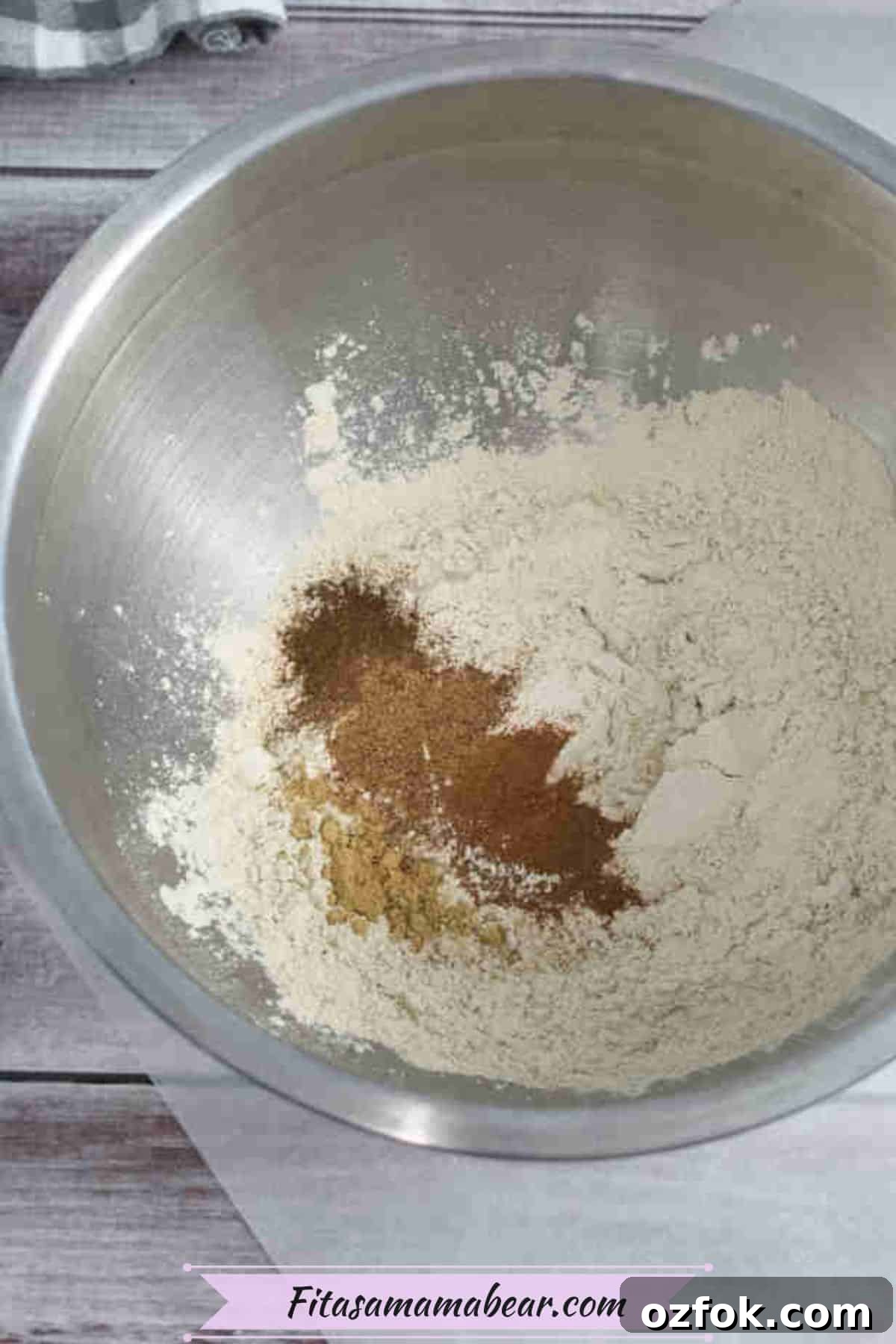 5-Minute Gingerbread Protein Bars Recipe for Quick Snacks 4 Steel bowl with protein powder and cinnamon in it.