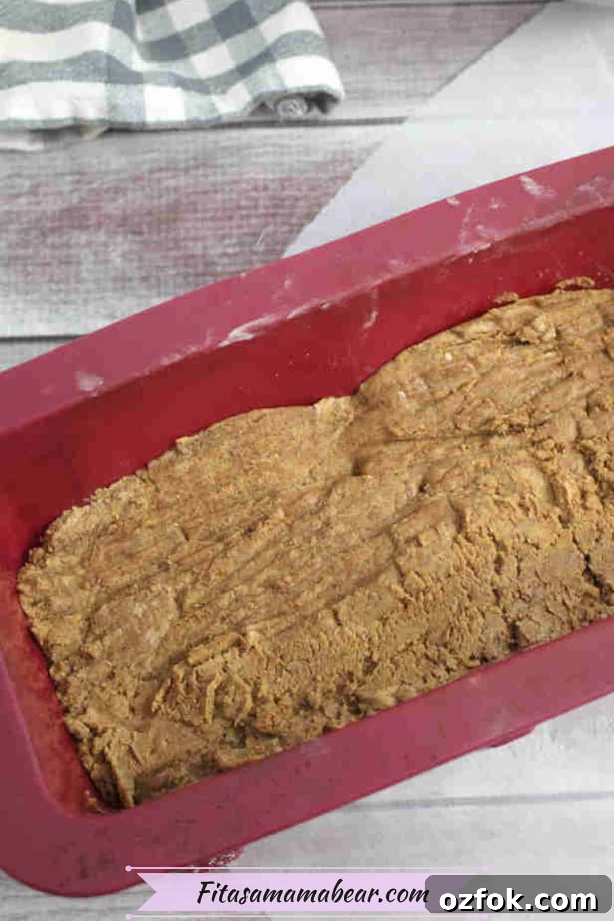 5-Minute Gingerbread Protein Bars Recipe for Quick Snacks 6 Red silicone mold with no bake protein bar batter in it.