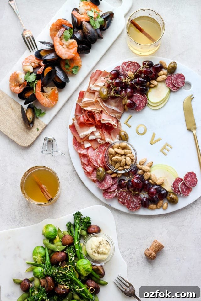 Romantic Valentine's Day Dinner for Two - a delicious and fun tasting boards for two! A narrow seafood charcuterie board, large round marble stone charcuterie board, and a cooked vegetable board.