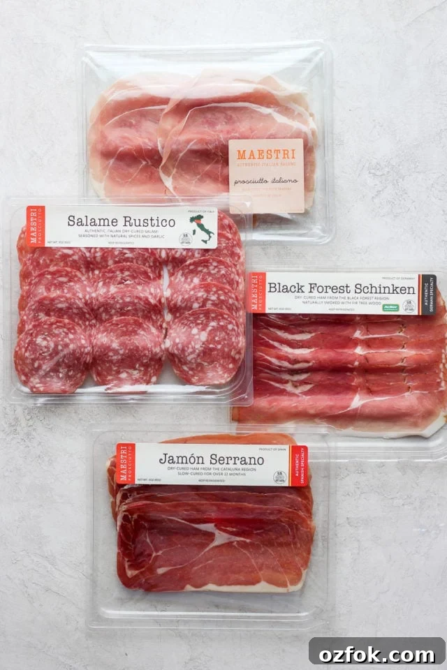 European Charcuterie Set Four packages of deli meat used on the charcuterie board.