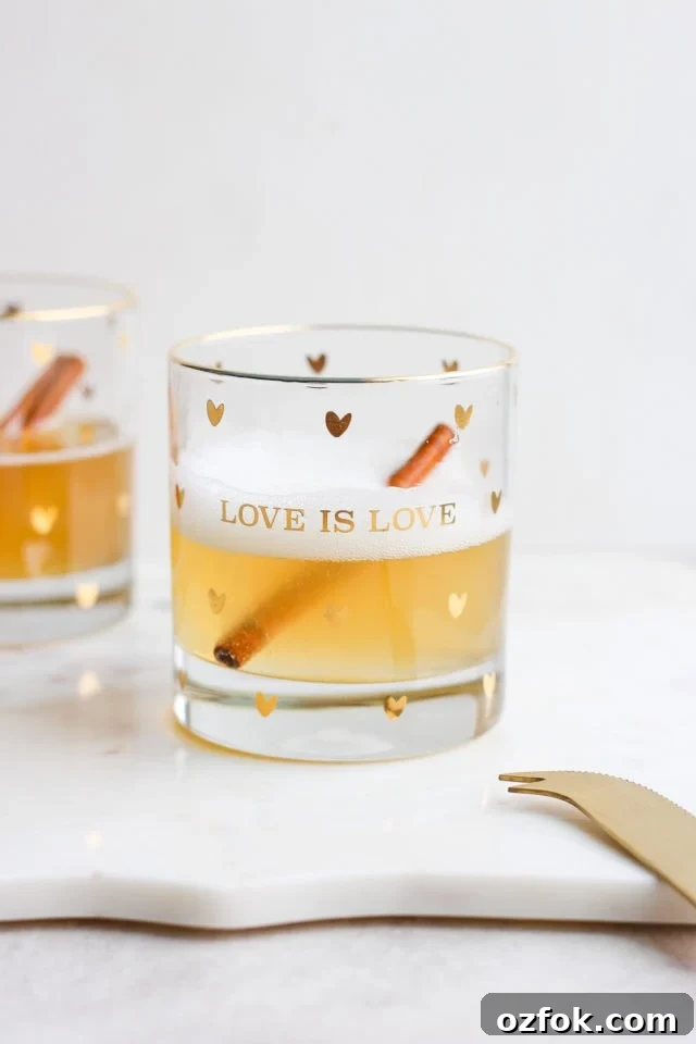 Champagne-Kombucha Spritzer Two glasses of champagne kombucha spritzer with cinnamon sticks in them.