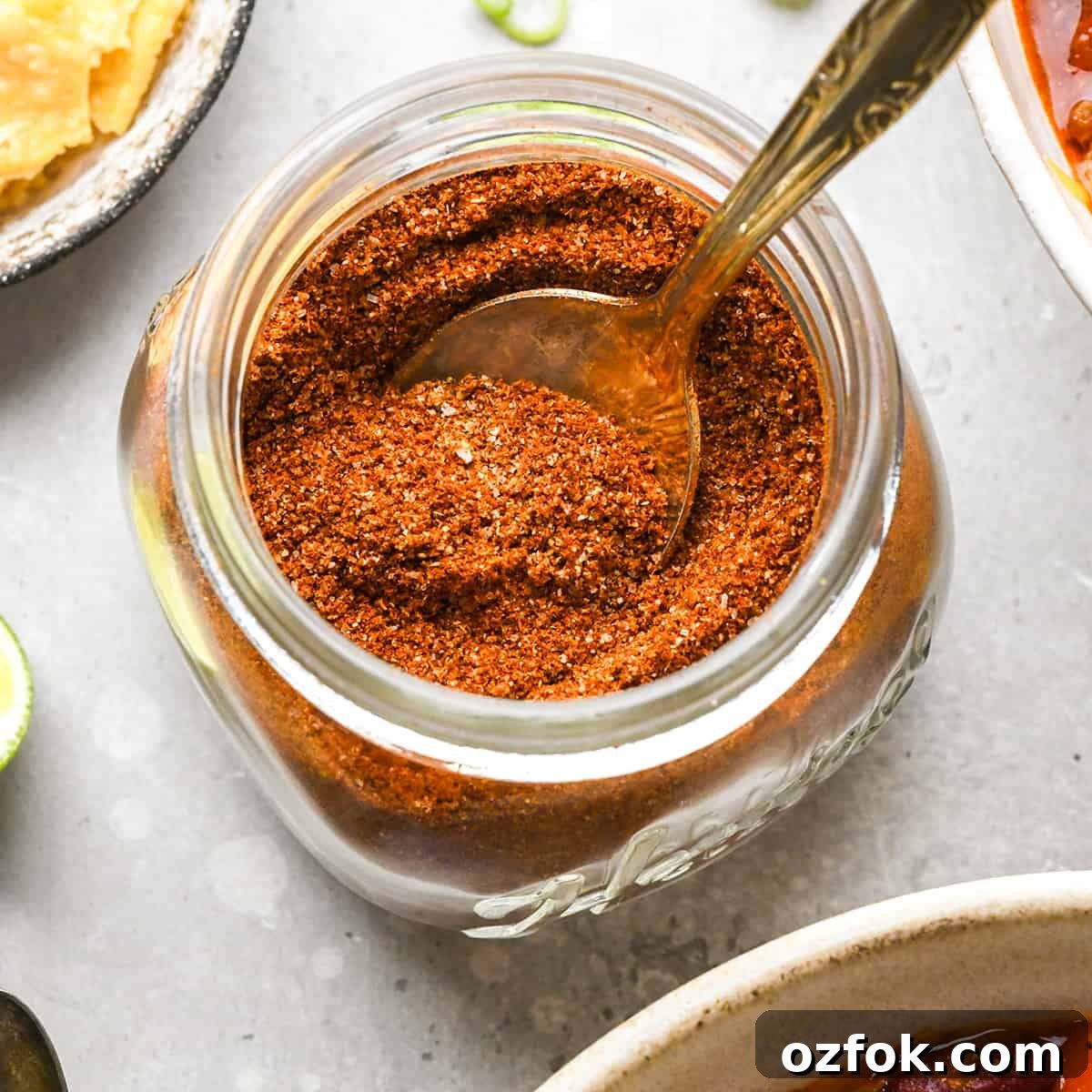 Homemade Chili Seasoning Blend for Bold, Authentic Flavor 5 Homemade Chili Seasoning Recipe in a glass jar with a spoon