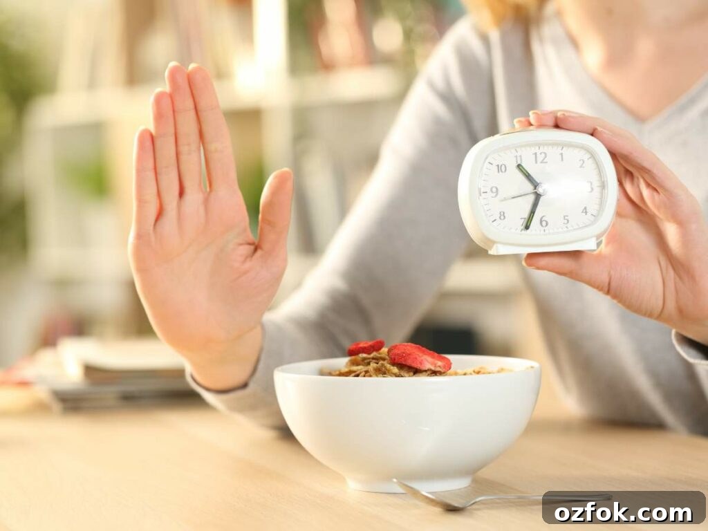 A woman holding an alarm clock and a bowl of cereal.
