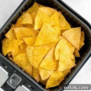 Crispy Air Fryer Tortilla Chips Recipe for Perfect Crunch 11 Air fryer basket filled with corn tortilla chips.