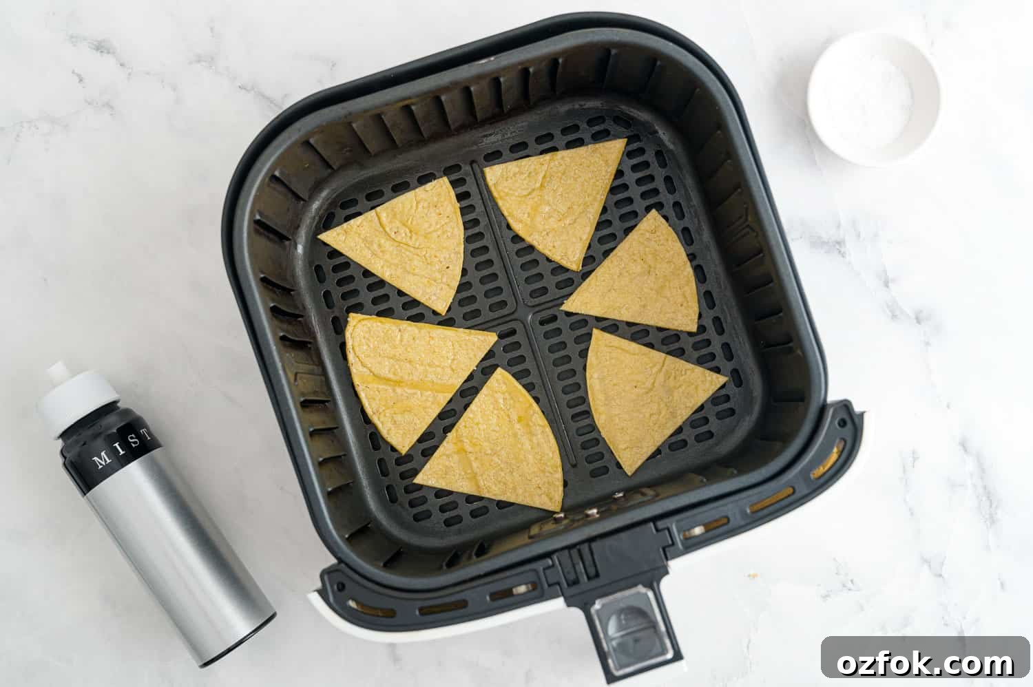 Crispy Air Fryer Tortilla Chips Recipe for Perfect Crunch 8 Uncooked tortilla chips in an air fryer.