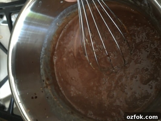 Dark Chocolate Gluten-Free Custard (with Dairy-Free Option) 5 Cooking chocolate custard and stirring with a whisk.