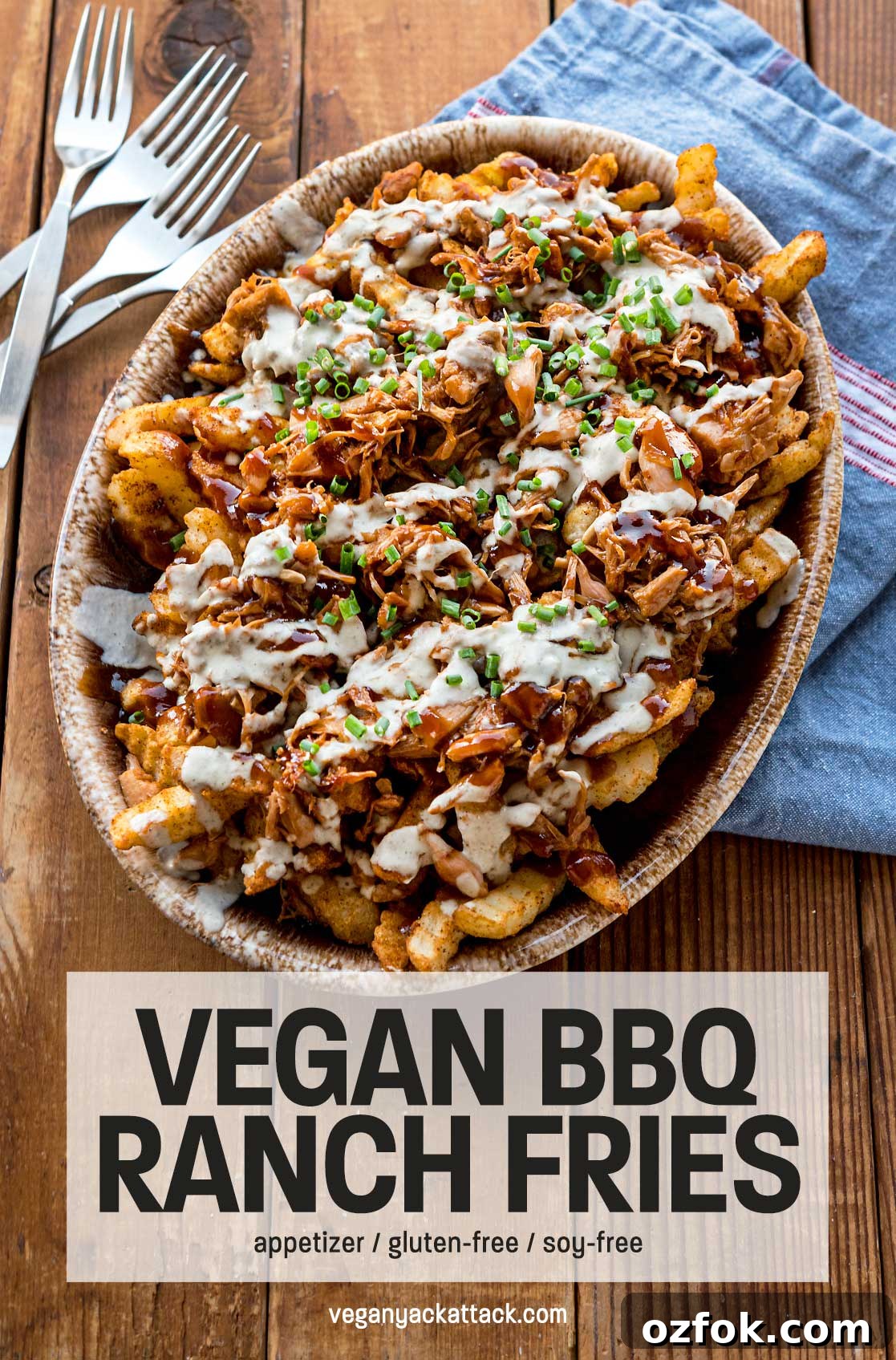 Vegan BBQ Ranch Fries — Perfect Party Appetizer 2 Oval platter with fries topped with jackfruit, sauces, and green onions on a wood table