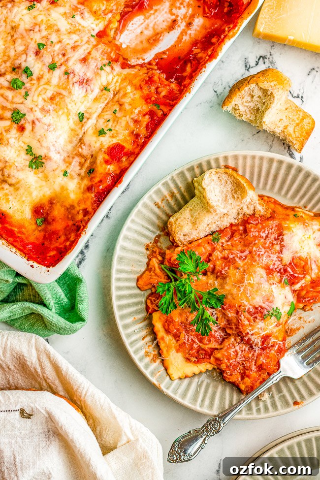 Cheesy Ravioli Lasagna Recipe: Layered Baked Pasta with Marinara 3 Cheesy Ravioli Lasagna on a plate next to a baking dish of the lasagna.