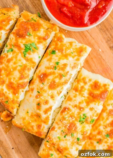 Cheesy Ravioli Lasagna Recipe: Layered Baked Pasta with Marinara 6 Easy Cheesy Garlic Bread slices.