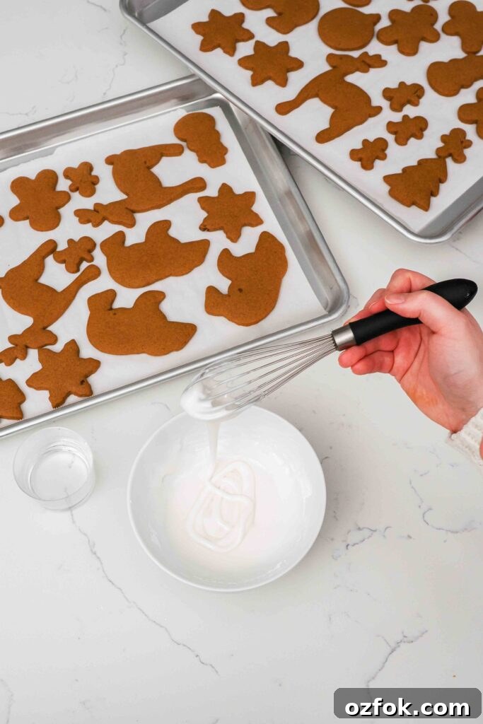 A whisk trails powdered sugar icing into a bowl.