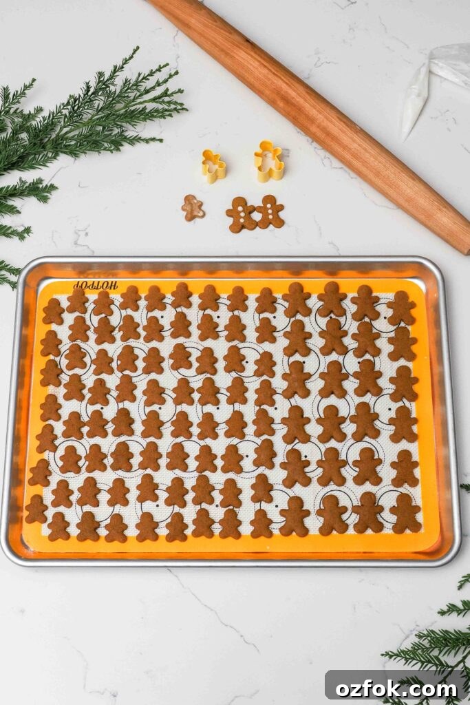 A baking sheet with mini gingerbread cookies.