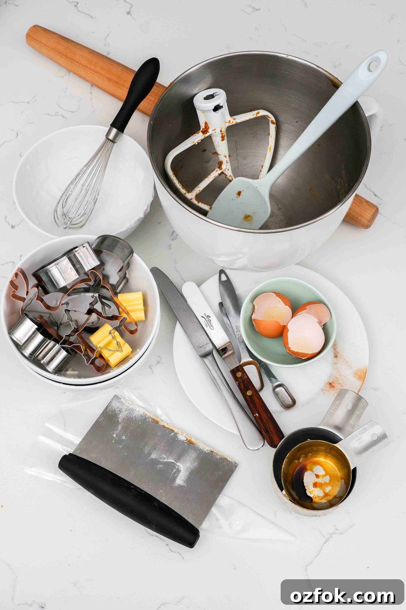 Dishes used to make gingerbread cookies on a counter.