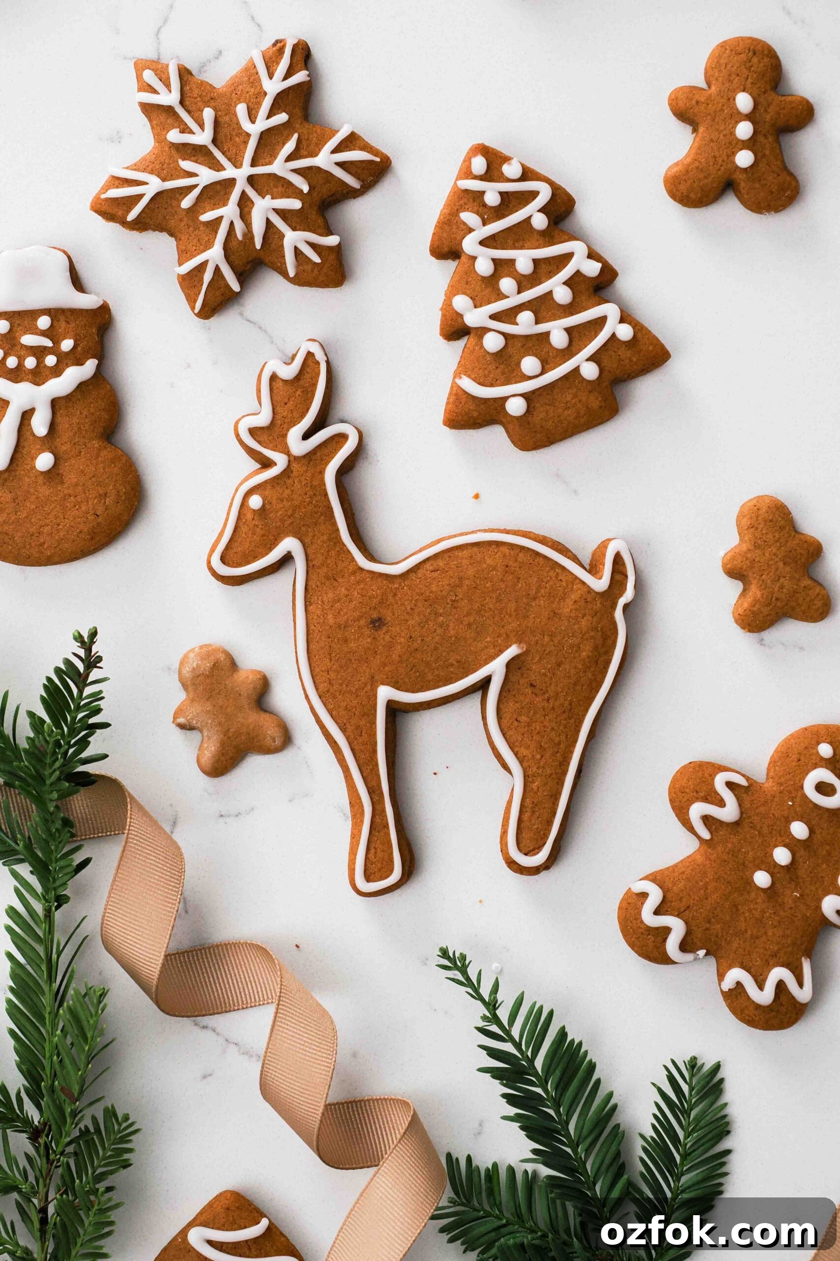 A gingerbread reindeer amongst other gingerbread cookies.