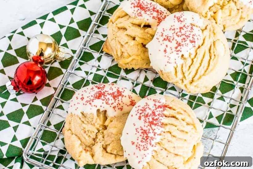 White Chocolate Peanut Butter Cookie Recipe for Chewy Cookies 7 Peanut butter white chocolate chip cookies on a wire rack next to Christmas ornaments.