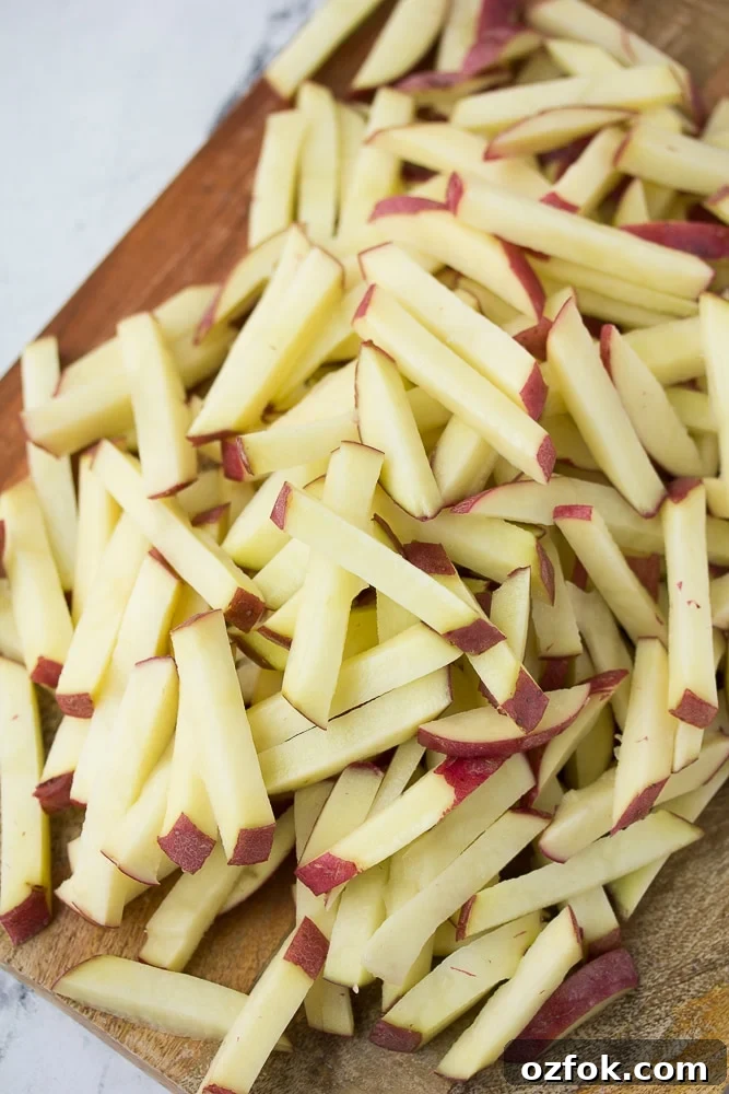Crispy Air Fryer French Fries Recipe 3 cut potatoes not yet cooked in a pile