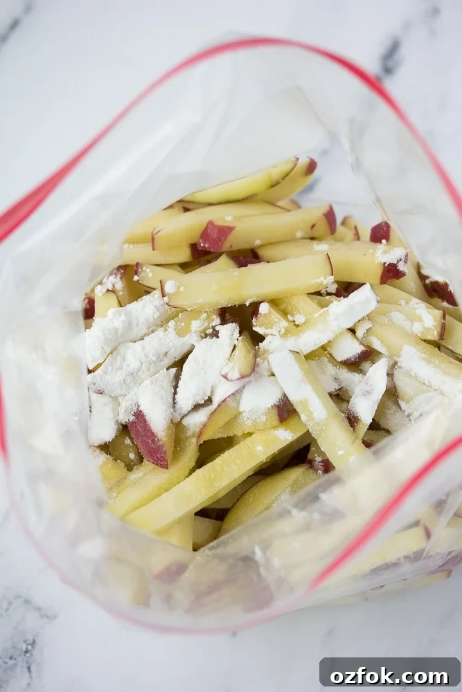Crispy Air Fryer French Fries Recipe 4 cut potatoes in a plastic bag with cornstarch and oil