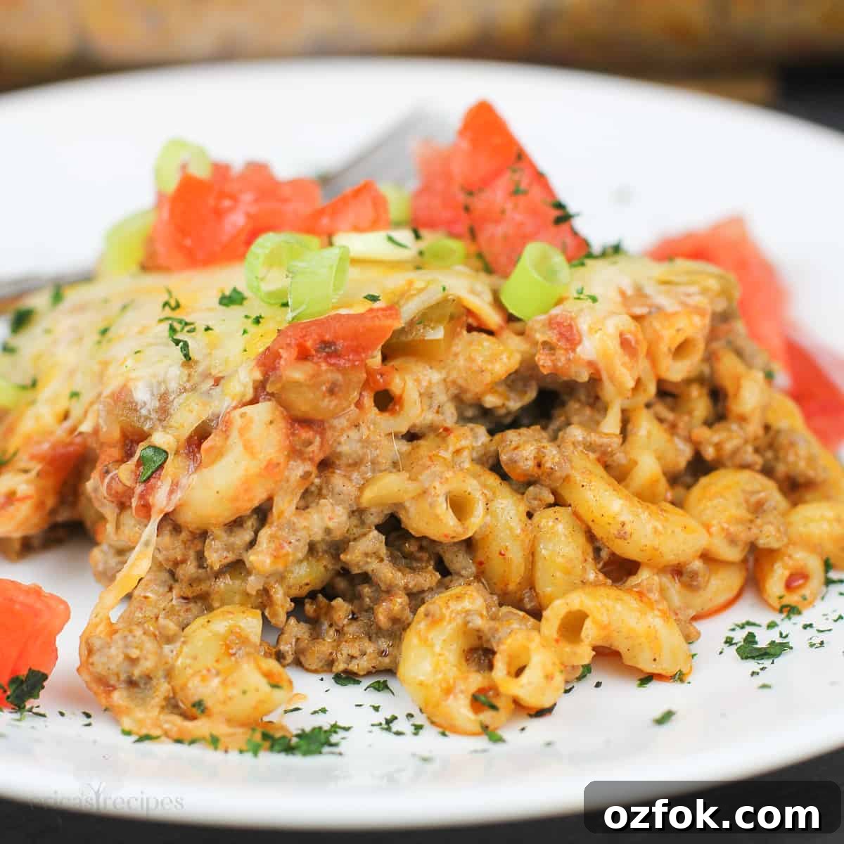 Taco Beef and Macaroni Casserole: Cheesy One-Pan Dinner 3 taco macaroni and beef on white plate