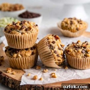 Gluten-Free Dairy-Free Zucchini Muffins Recipe 12 Gluten-free zucchini muffins lined up and two are stacked.