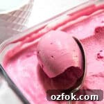 Plum & Blackberry Frozen Yogurt with Fresh Sage 3 Plum frozen yogurt being scooped up with a spoon.