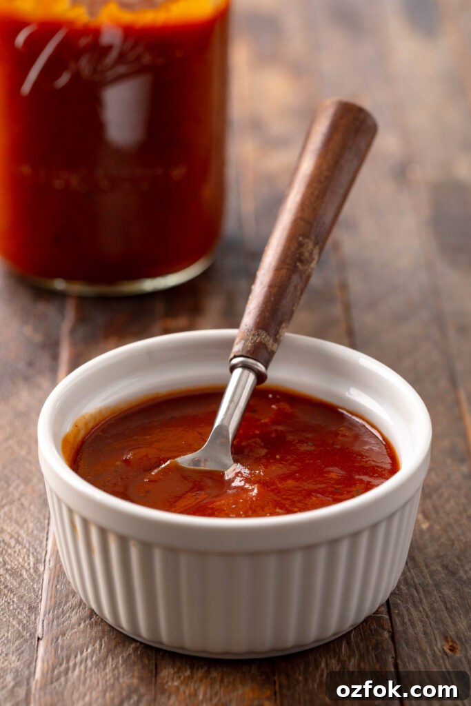 Sweet and Spicy Barbecue Sauce Recipe for Grilling and Dipping 2 bowl of sweet & spicy bbq sauce with a spoon in it