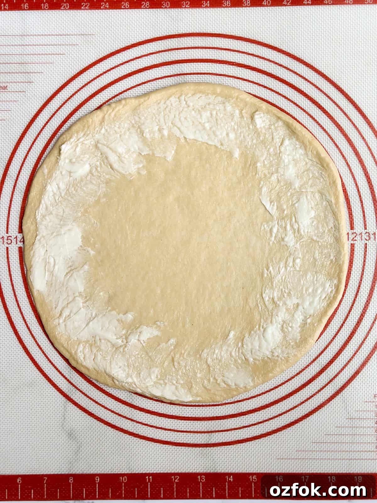 Flaky Homemade Buttery Dinner Rolls Recipe 9 butter around the edge of the circle.