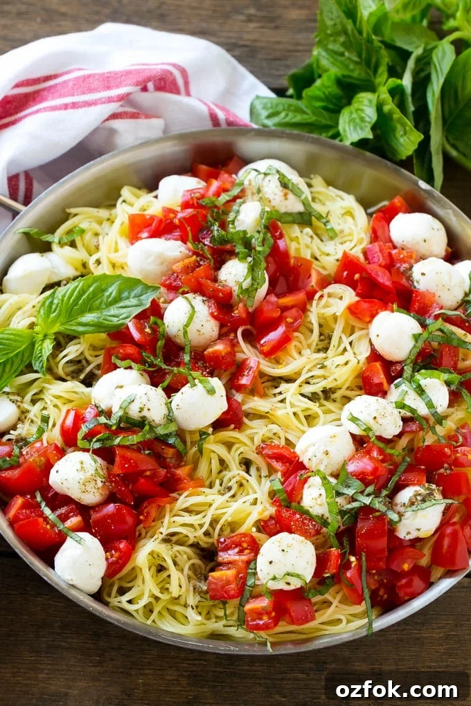 Caprese Pasta Recipe | Easy Pasta Recipe | Fresh Tomato Pasta | Caprese Recipe A pan of angel hair caprese pasta topped with olive oil, tomatoes, basil and fresh mozzarella.