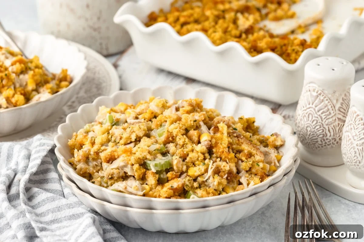 A bowl of chicken and stuffing casserole sits in front of a baking dish containing more casserole.
